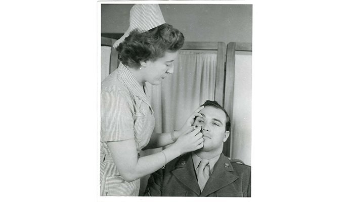 Nurse preparing to insert artificial eye for patient
