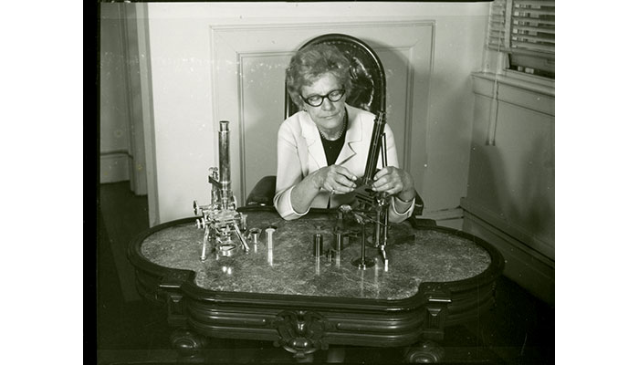 Helen R. Purtle with some instruments from the Billings Microscope Collection